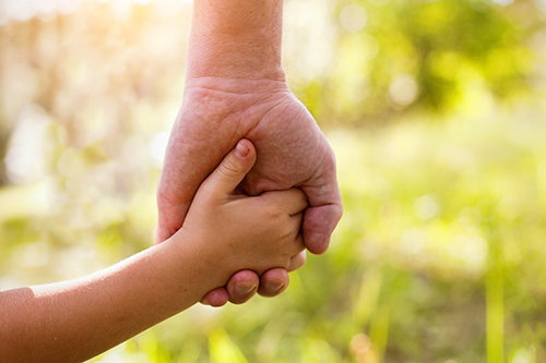 Child holding parents hand